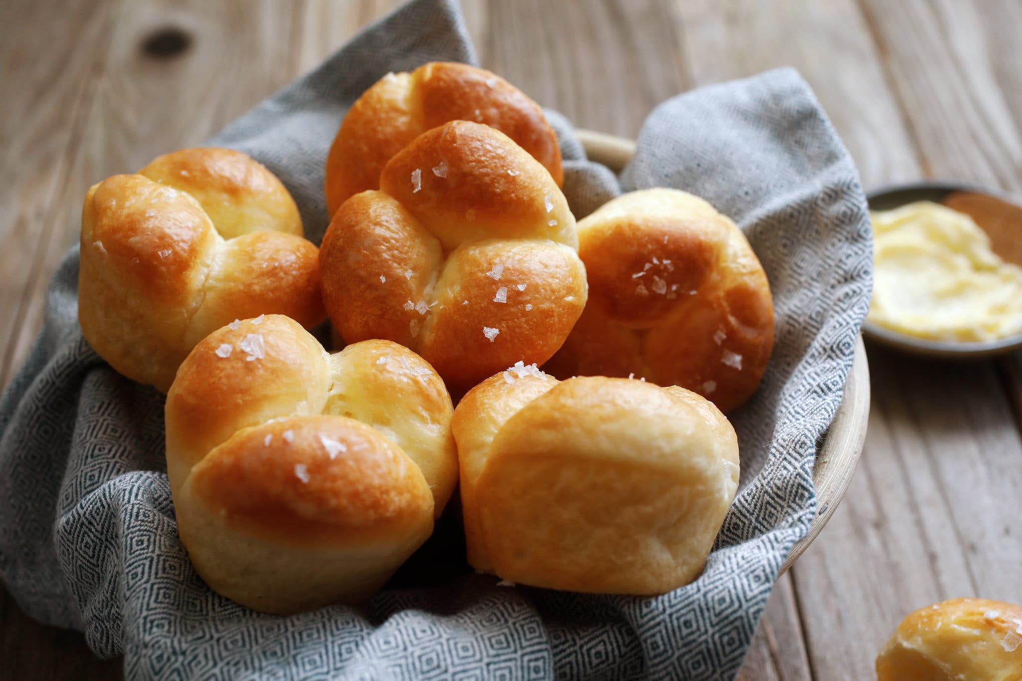 A napkin-lined basket of rolls photographed from an angle.