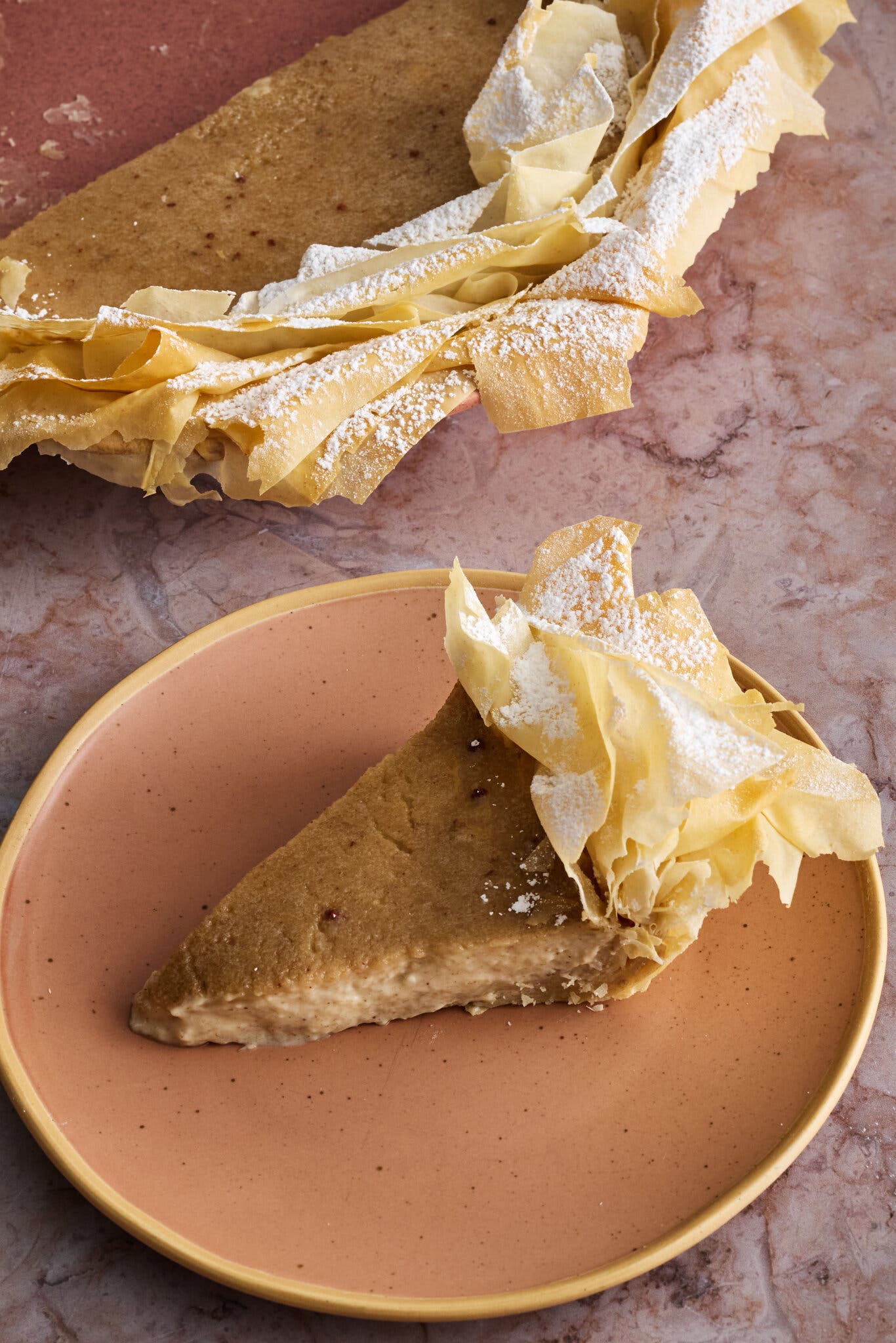 A three-quarter image of a banana pie with a phyllo crust.